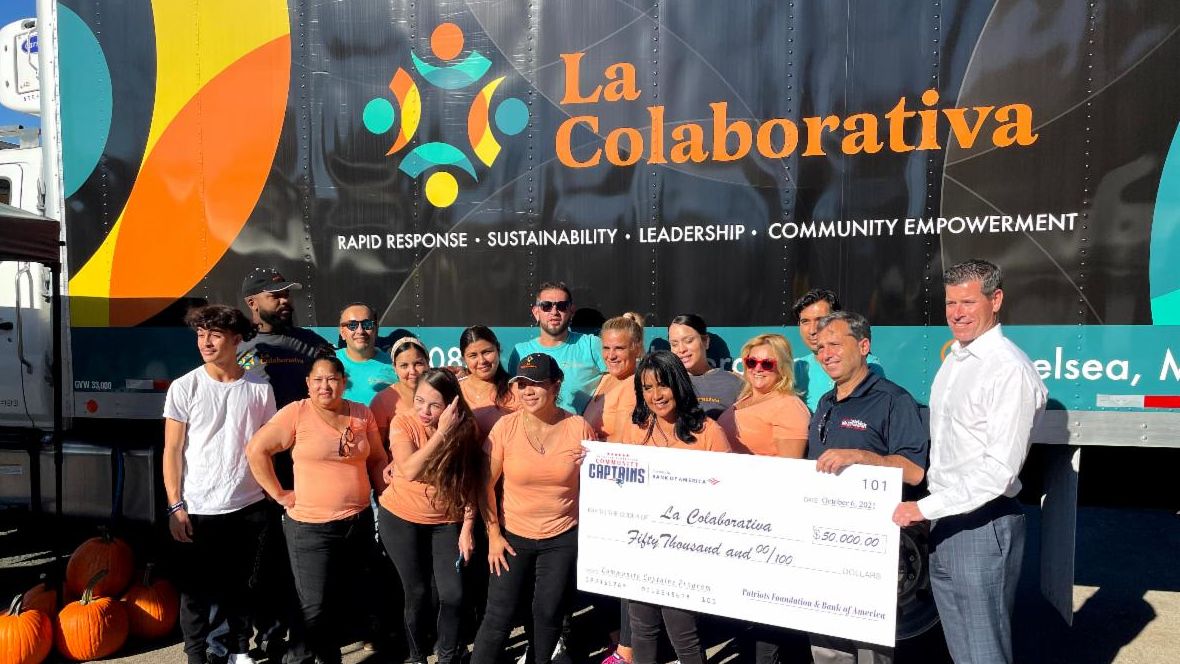 a group of people with a large check