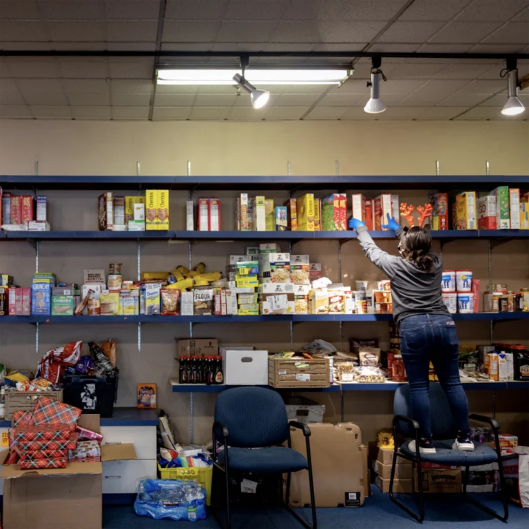 Person organizing food on shelves